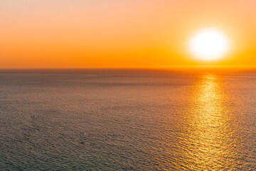 Bright sunset with large yellow sun under the sea surface