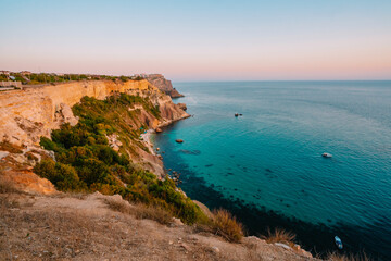 Sunset on Cape Fiolent, panorama of the black sea with azure water, Crimea