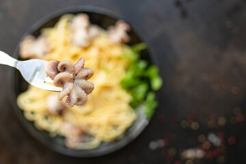 spaghetti pasta baby octopus seafood warm salsd fresh second course on the table tasty serving size top view copy space for text food background rustic