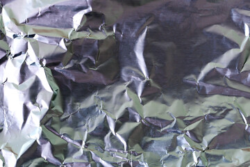 Crumpled silver foil as a texture. Abstract background