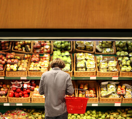 Young man buying vegetables at the market