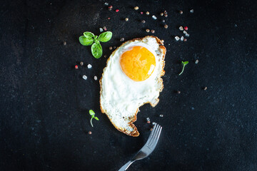fried egg yolk and white, fork for eat omelette fresh dish and ingredients on the table tasty serving size top view copy space for text food background rustic
