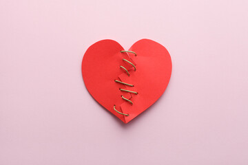 broken paper red heart isolated on pink background, top view, flat lay