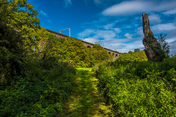A view up a grassy path towards the Digswell Viaduct near Welwyn Garden City, UK in the summertime