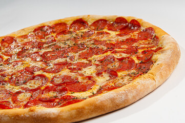 Pepperoni pizza on white background. Copy space. Selective focus