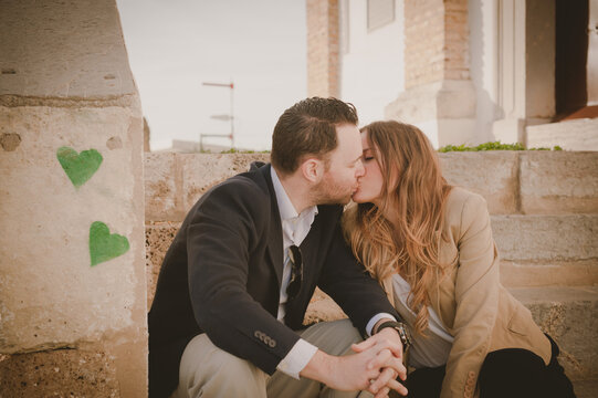 Couple Kissing And Sitting On Steps