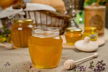 Linden honey in a glass jar with rustic decor