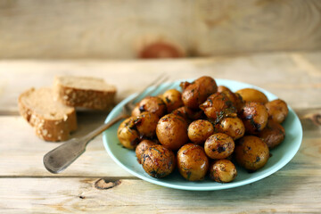 Selective focus. Baked potatoes in their skins. Mini potatoes in a plate. Healthy food.