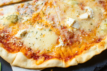 cheese pizza four types of cheeses varieties tomato sauce fresh ingredients fast food on the table tasty serving size top view copy space for text food background rustic