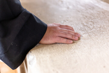 Man's palm and sleeve of the man's robe