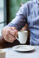 Businessman sitting in a cafe and drinking morning coffee