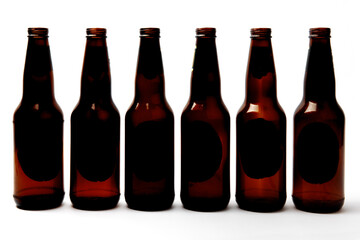empty beer bottles all in a row isolated on white