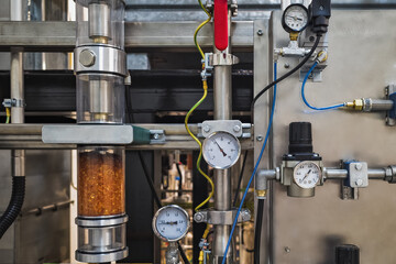 Gauge closeup, pressure measurement . Pipes and valves in the industrial enterprise.