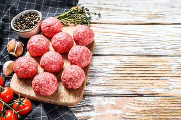 Raw meatballs made from ground beef. White background. Top view. Copy space