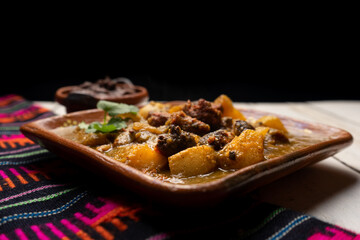 Mexican longaniza with green sauce and potatoes on white background