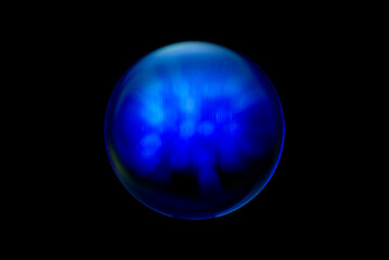 Blurry image of a shiny crystal ball with abstract blurry colorful pattern. Abstract lensball in blur.