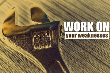 Work on your weaknesses phrase on a background with wrench key - inspiration and motivation
