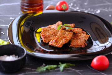 Lamb slow stewed with vegetables in a bowl close-up on dark marble background. meat dish