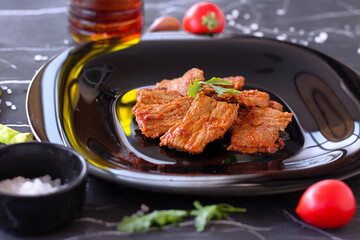 Lamb slow stewed with vegetables in a bowl close-up on dark marble background. meat dish