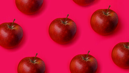 Red apple rows on pink background. Fruits background