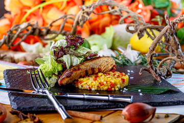 Beef steak with rice and vegetables are on the plate