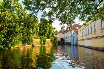 Fototapeta na wymiar The architecture of the strago city of Prague. River channel in the city. Streets of old Europe, cityscape