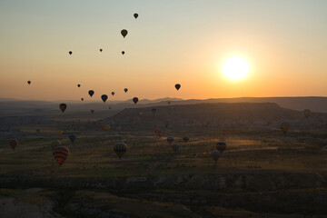 Balloons flying over Cappadocia at sunrise. Cappadocia, Turkey.