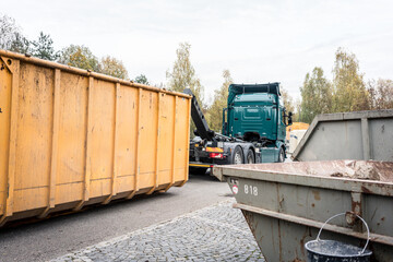 Fototapeta na wymiar Truck loading container with waste on recycling center