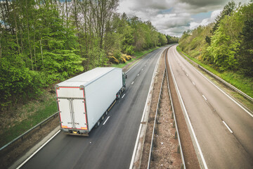 A truck on a dual carriageway - no cars on motorway but one lorry - obrazy, fototapety, plakaty