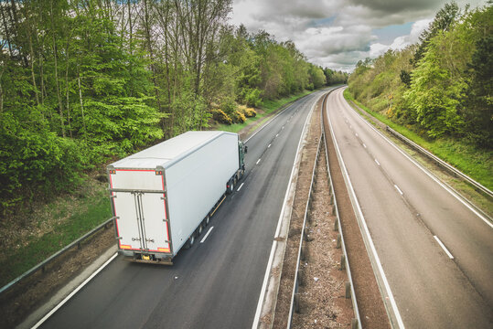 A truck on a dual carriageway - no cars on motorway but one lorry