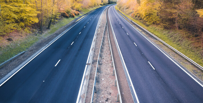 Empty dual motorway in UK - lockdown affects not only road traffic and transportation but also petrol prices