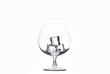 empty glass with ice cubes on white background