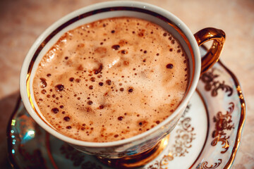 beautiful gold Cup of Cappuccino Coffee on the table