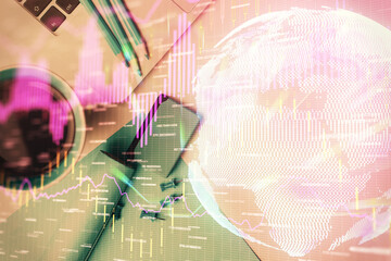 Double exposure of forex graph drawing over desktop background with computer. Concept of financial analysis. Top view.