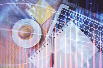 Double exposure of forex chart drawing over table background with computer. Concept of financial research and analysis. Top view.