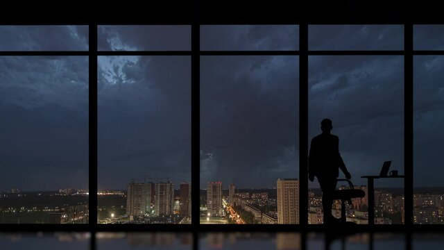 The businessman working in the office on the rainy city background. time lapse