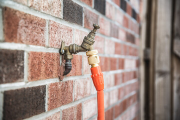 Garden tap mounted on a brick wall