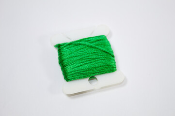 Sewing thread in green color with white background