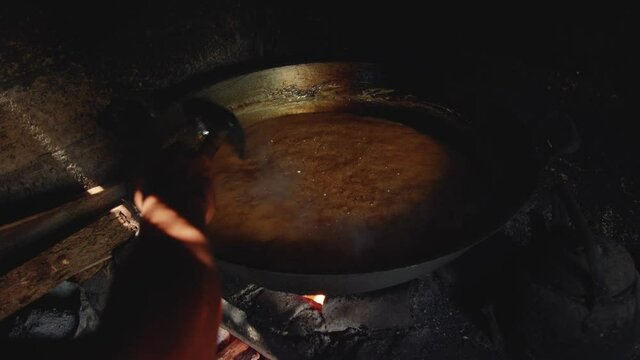 Stirring coconut nectar or neera to make solid organic coconut sugar