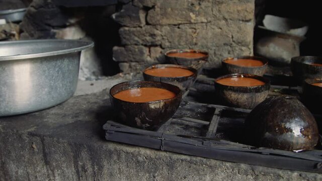 Coconut sugar made from neera or coconut nectar solidifying in coconut shells