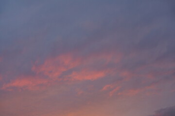 Naklejka na ściany i meble Orange blue grey clouds in the sky
