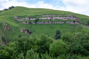 Obraz premium Mountain landscape with blue sky. Panoramic view of green hills.