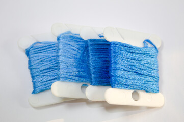 Sewing thread in blue color with white background