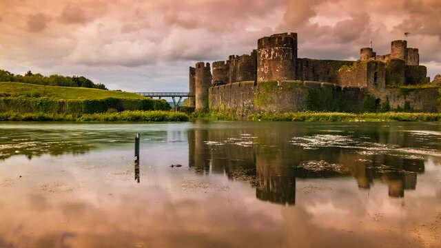 Stunning sunset timelapse shot of Caerphilly Castle in Wales, UK built by Gilbert de Clare in 1268 to maintain control of Glamorgan