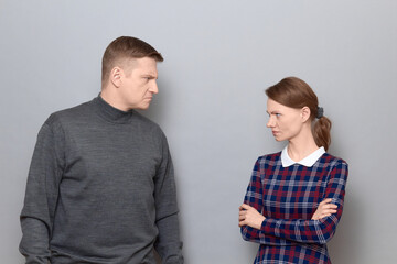 Portrait of angry man and woman looking with grudge at each other