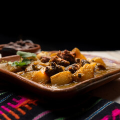 Mexican longaniza with green sauce and potatoes on white background