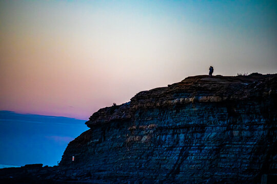 silhouette of a man standing on a rock