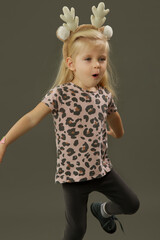 Studio shot of 3 years old fashionable kid on the grey background	