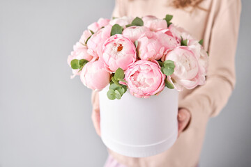 Round box with Bouquet of Pink peonies in a women hand. Beautiful peony flower for catalog or online store. Floral shop concept . Beautiful fresh cut bouquet. Flowers delivery © malkovkosta