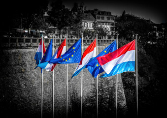 Waving flags of Luxembourg and the European Union in the city of Lucembourg